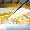 poutre en bois / lamellé-collé / cintrée / pour toiture à double pente - COMPLEXE SPORTIF