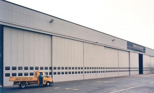 Porte industrielle coulissante - ESAVIAN : TYPE 127 - Jewers Doors - en acier / isolante / pour hangar