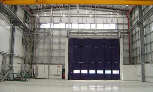 Porte industrielle pliante - ESAVIAN : TYPE 1200 - Jewers Doors - en aluminium / étanche / pour hangar