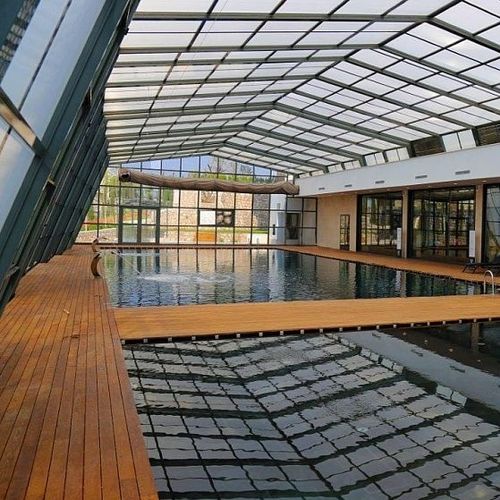 Abri de piscine haut - EVOLUTION LEAN-TO - Evergreen Solutions - adossé / rétractable / en aluminium