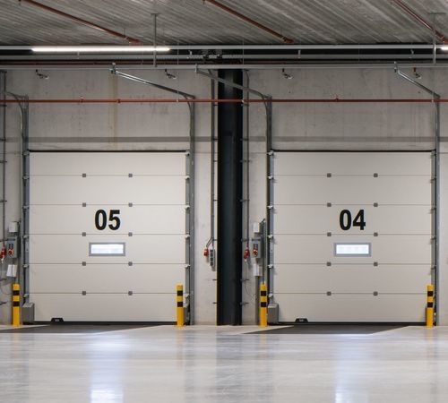 Porte industrielle sectionnelle - CRAWFORD OH1142P DUAL DRIVE - ASSA ABLOY Entrance Systems - en acier / à isolation thermique / automatique