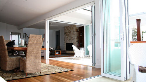 Baie vitrée coulissante-empilable - GENESIS - Capral Aluminium - pliante / en aluminium / à double vitrage