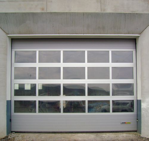 Porte industrielle sectionnelle - K-VISION - KOPRON - en fonte d'aluminium / automatique / de sécurité