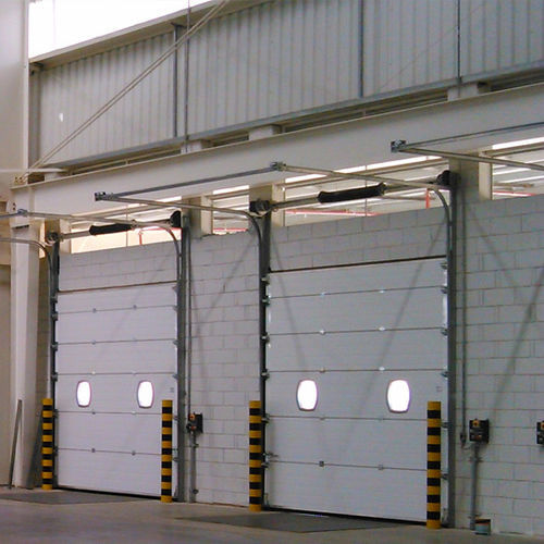 Porte industrielle sectionnelle - SEMI-VERTICAL LINTEL - KOPRON - en métal / automatique / à isolation thermique
