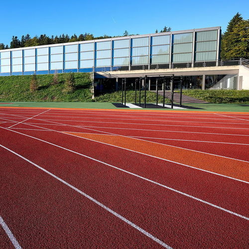 Sol sportif d'extérieur - RE-TOPPING SYSTEMS - Polytan GmbH - en élastomère / en caoutchouc / pour école
