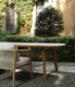 table à manger contemporaine / en céramique / avec piètement en teck / courbée