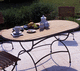 table contemporaine / en teck / avec piètement en métal / ovale