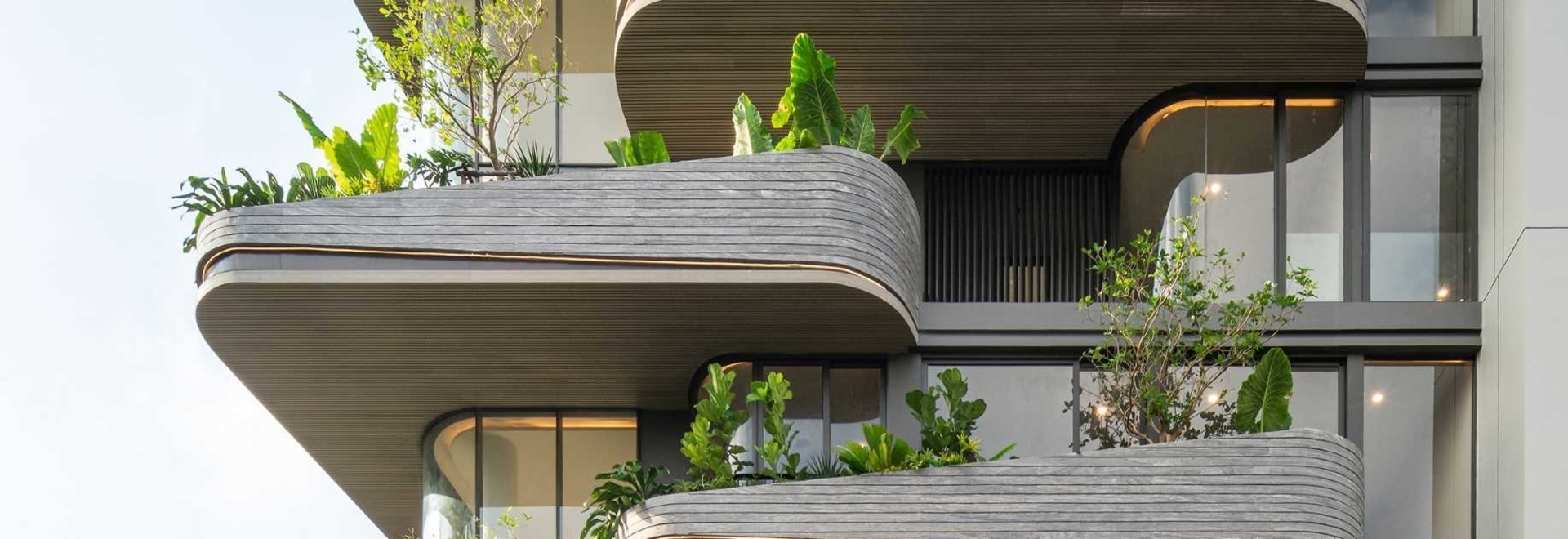 L'éclairage est utilisé pour mettre en valeur les balcons arrondis de ce bâtiment
