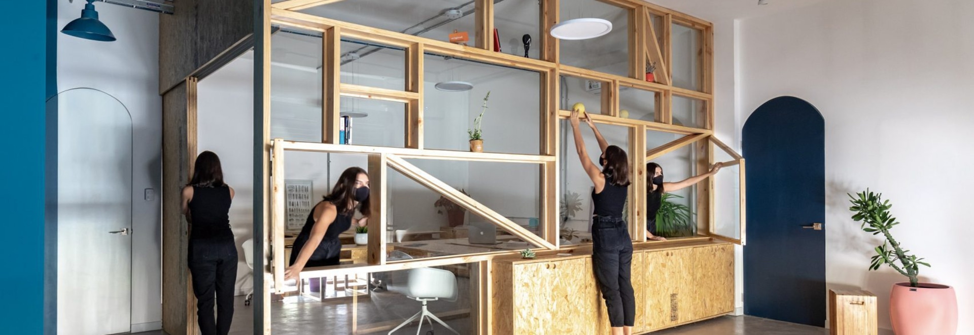 Des étagères en pin et en verre entourent un bureau en Équateur
