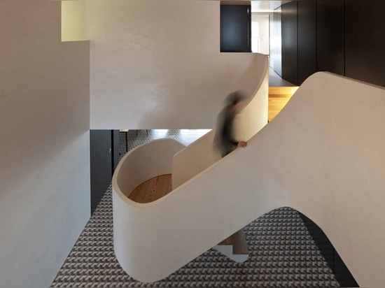 Correia/Ragazzi Arquitectos ajoutent courber l'escalier blanc à un appartement portugais transformé