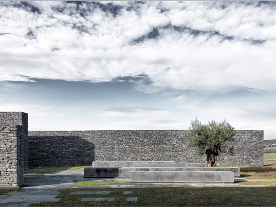 L'aménagement en terrasse entoure la structure en béton et en pierre de la mosquée de Sancaklar d'Emre Arolat