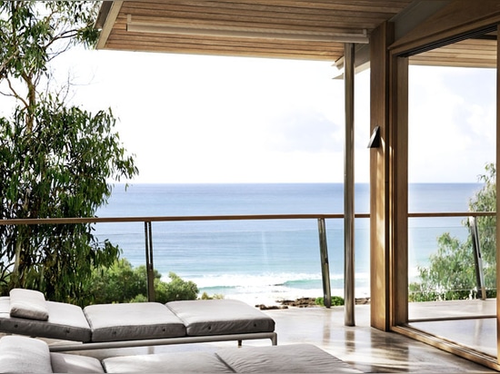 Chambre de plage en bois et en béton donnant sur l'océan